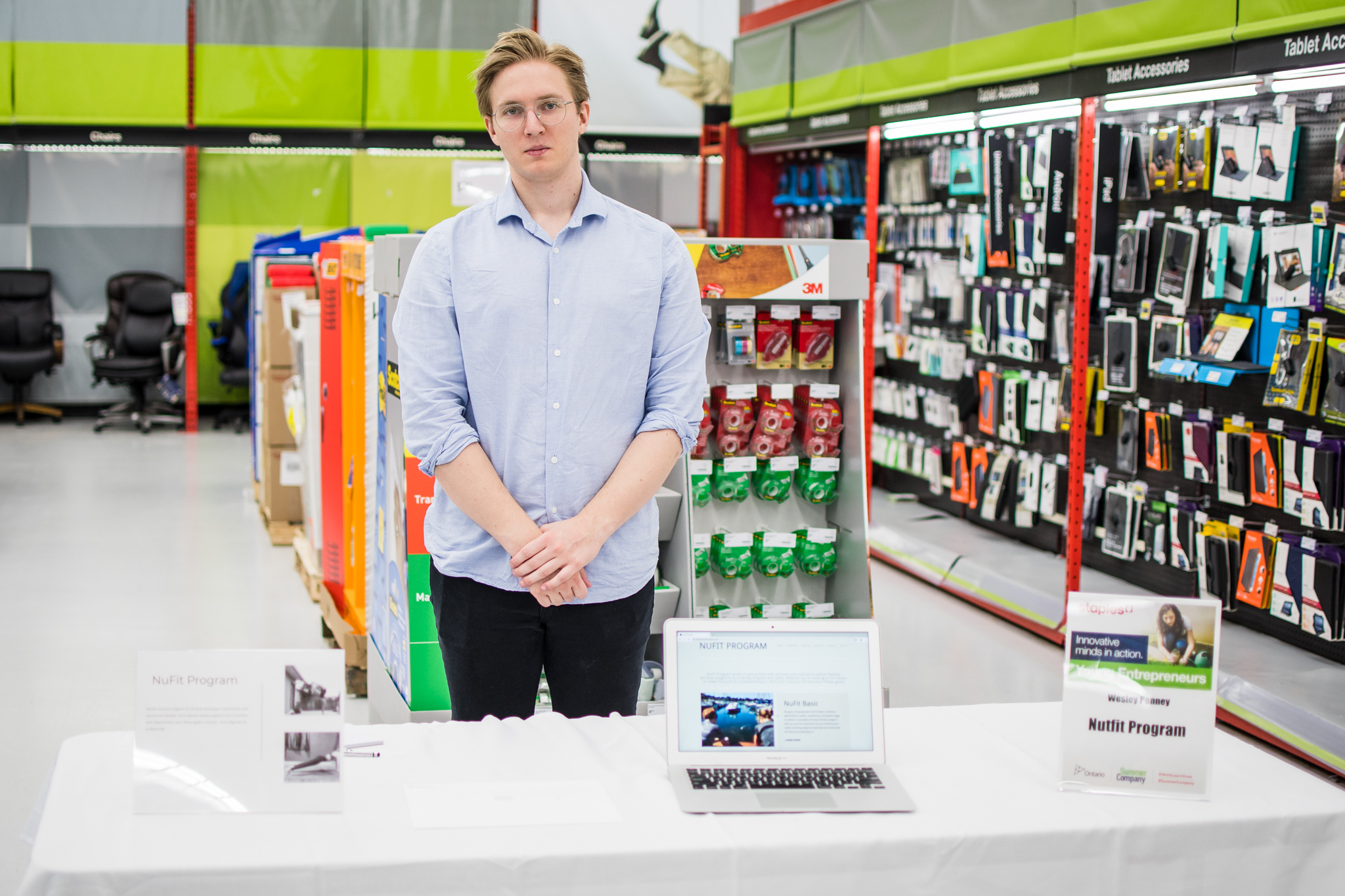 Man standing behind his booth for Staples Day