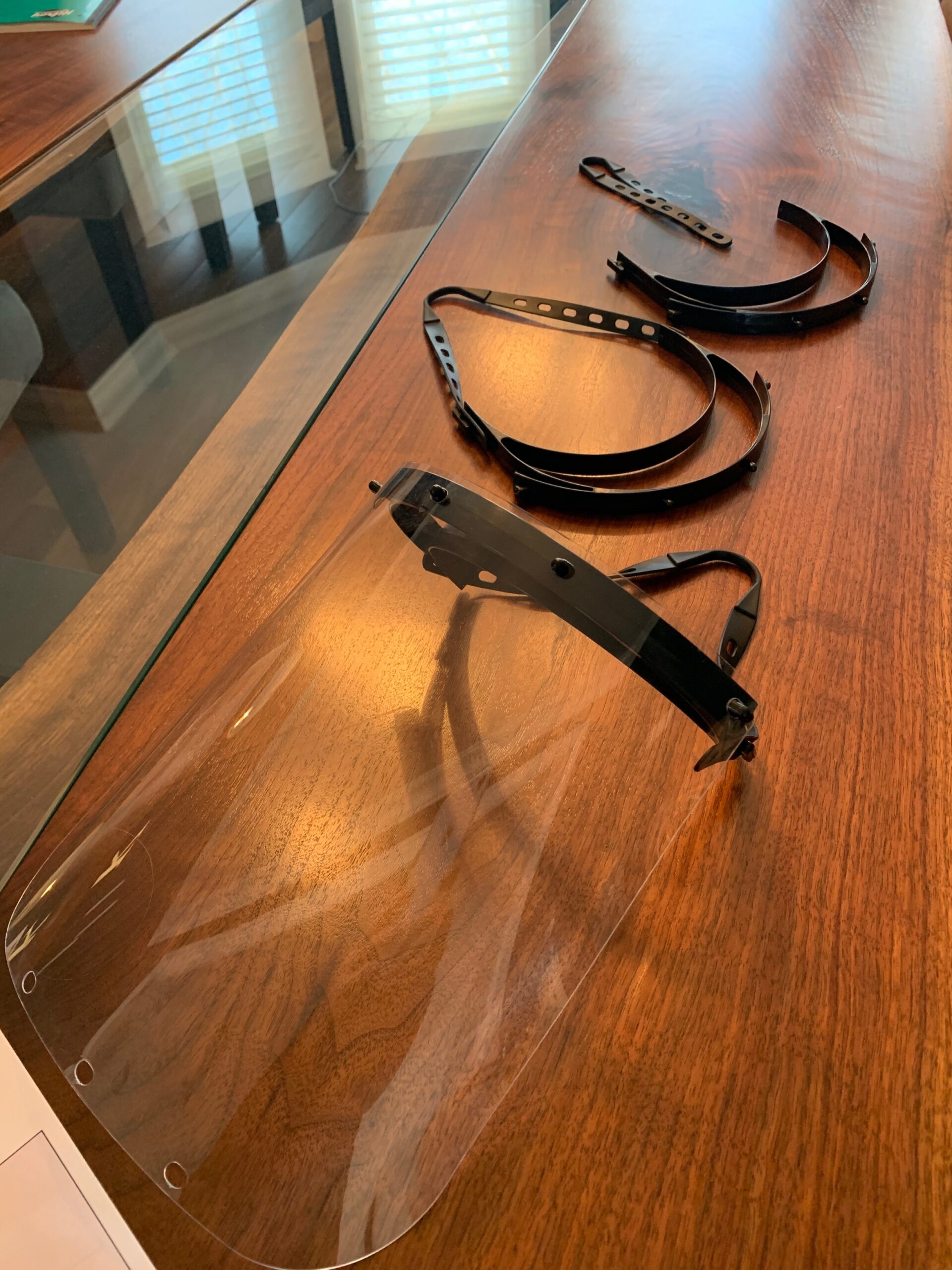 Face shield and its related equipment on a wooden table