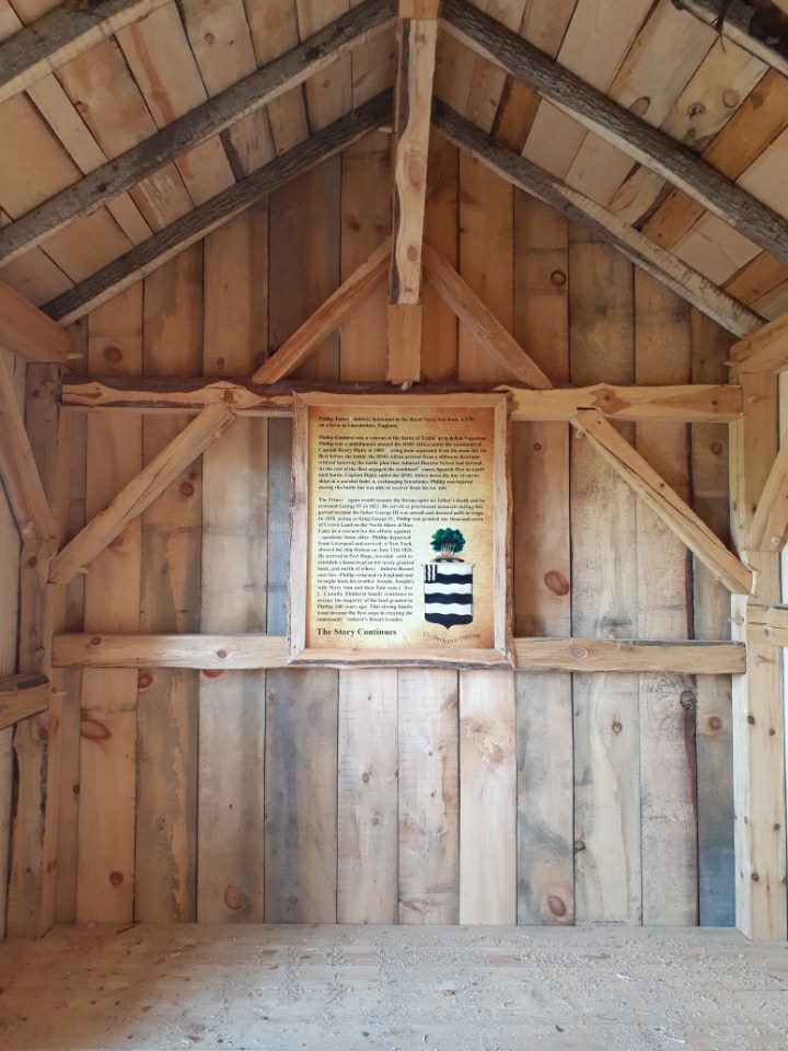 Inside of wooden cabin with an informative photo frame at the center