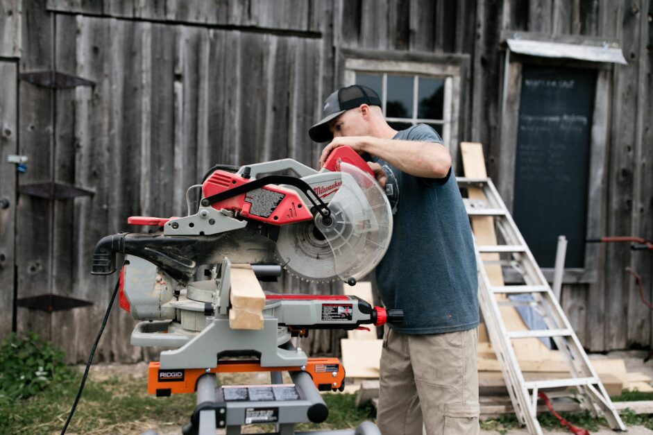 side view of a man with electric wood cutter