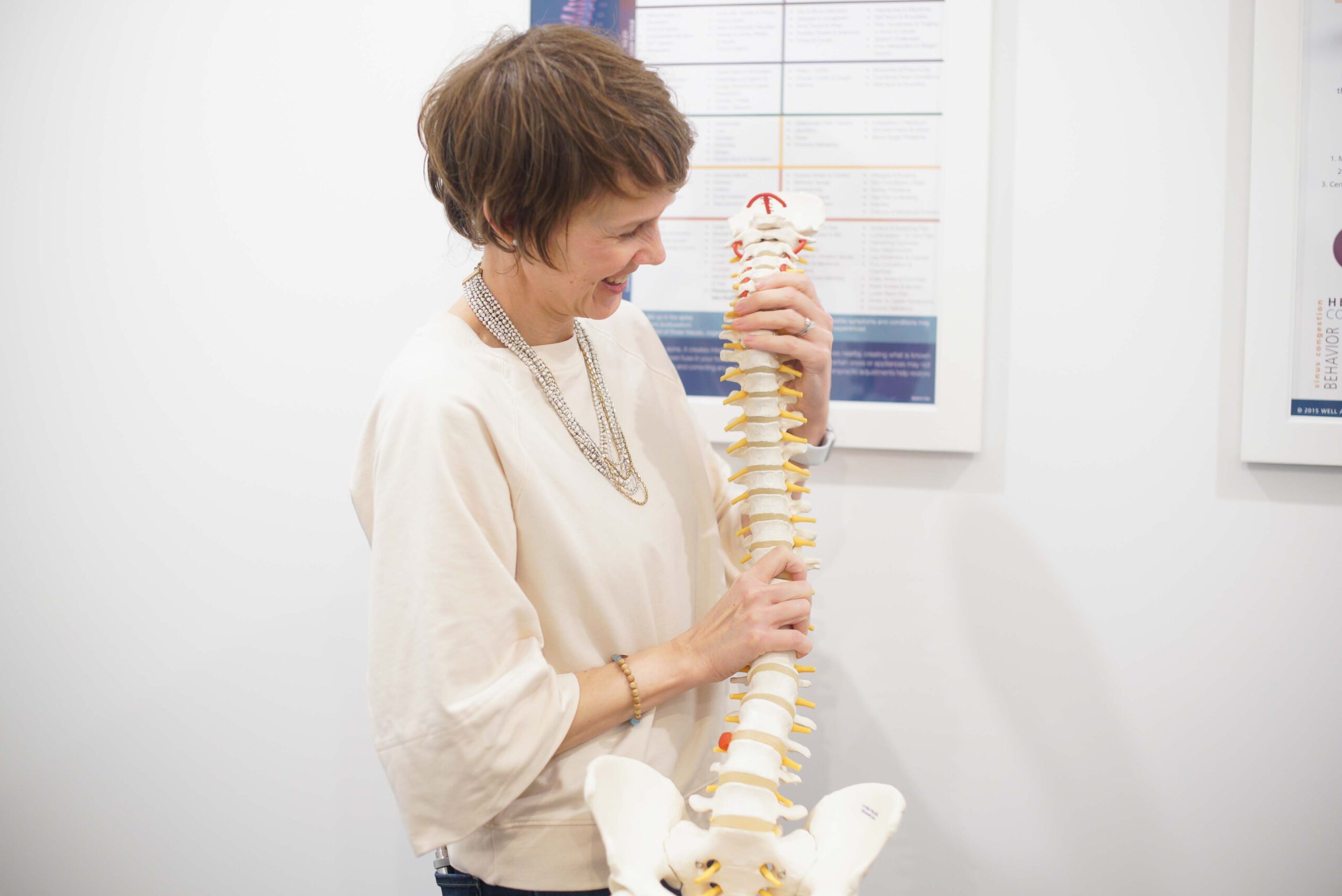 Dr. Ange Wellman with spine anatomical model
