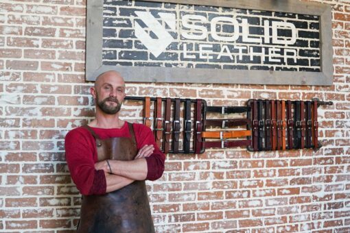 solid leather owner displaying leather belts