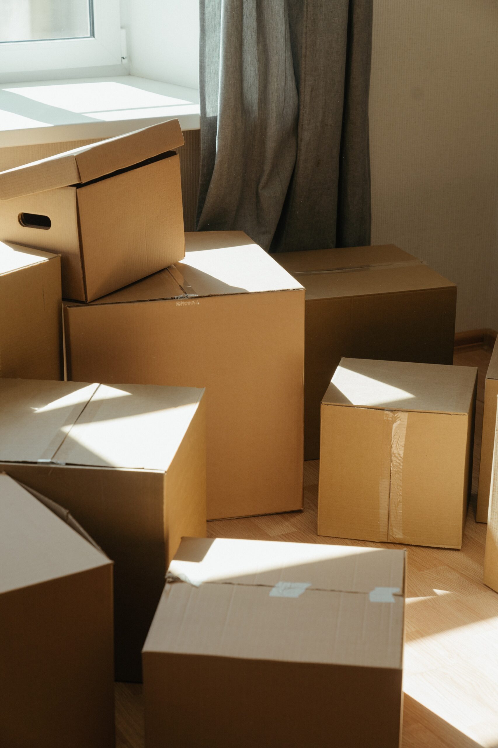 a pile of boxes kept near a window