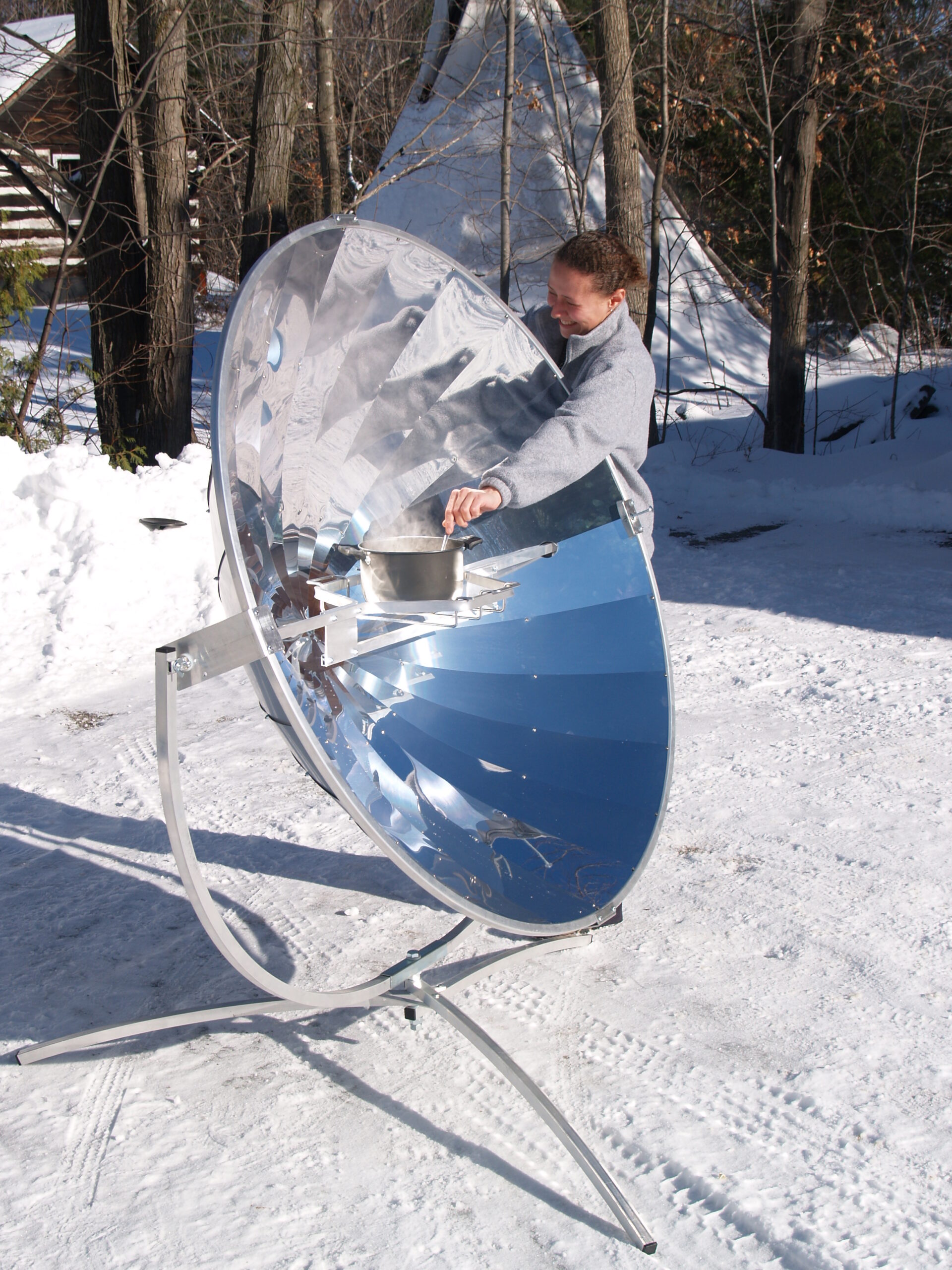 a person with solar cooker