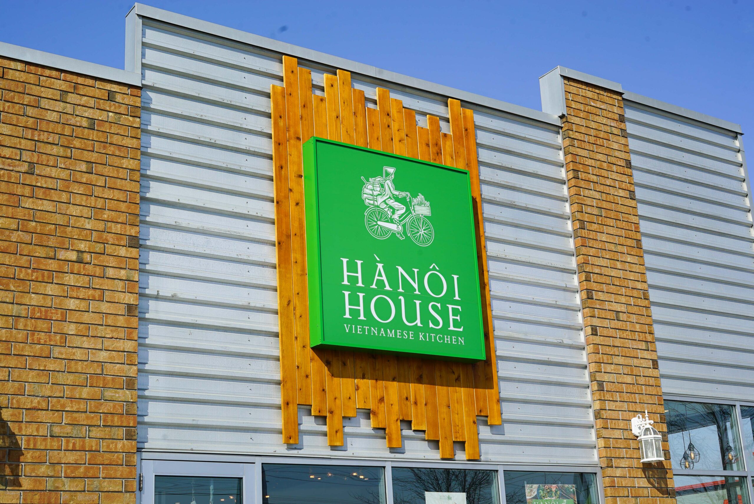 front view of a restaurant with green board