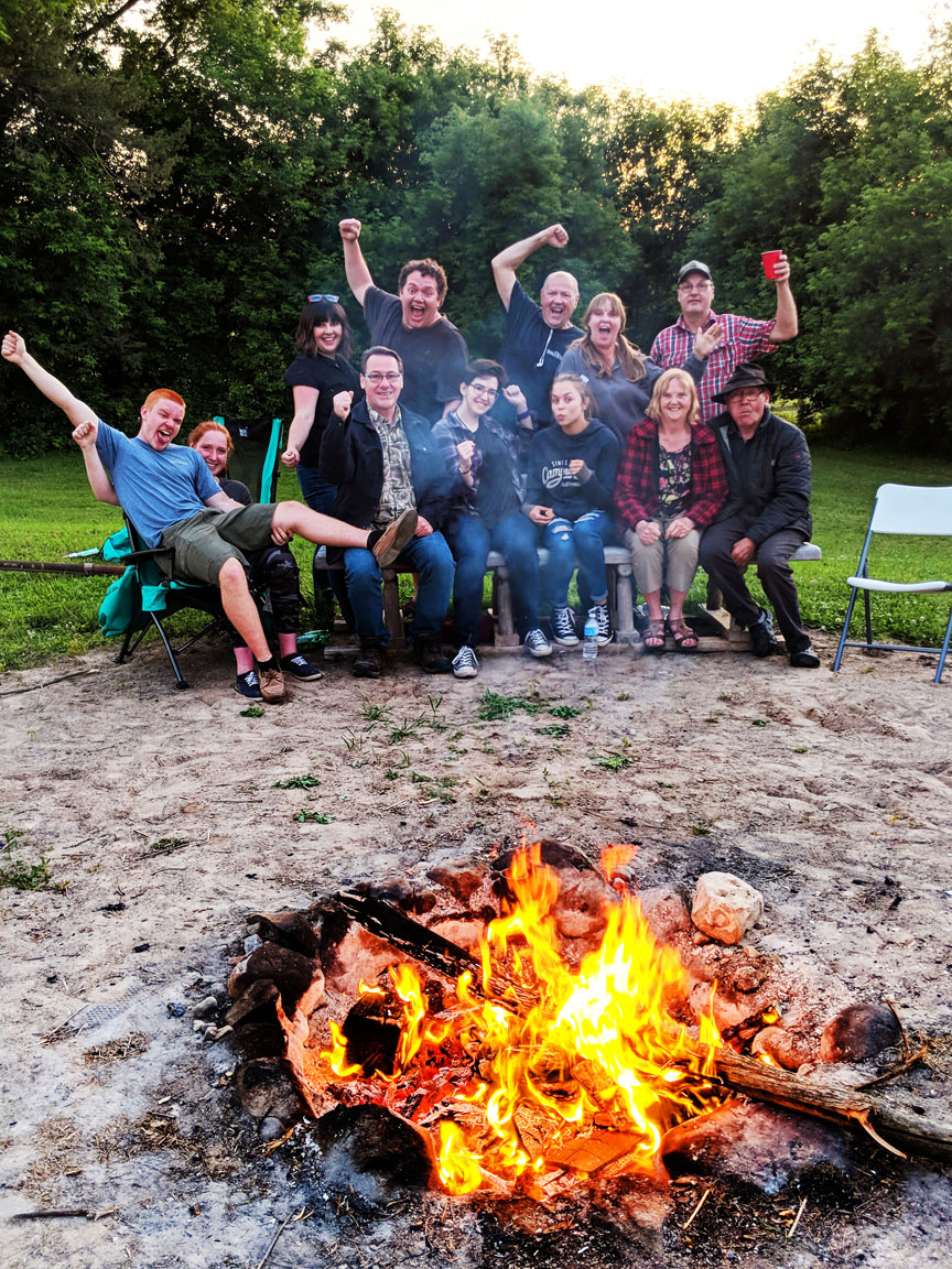 twelve people camping with bonfire