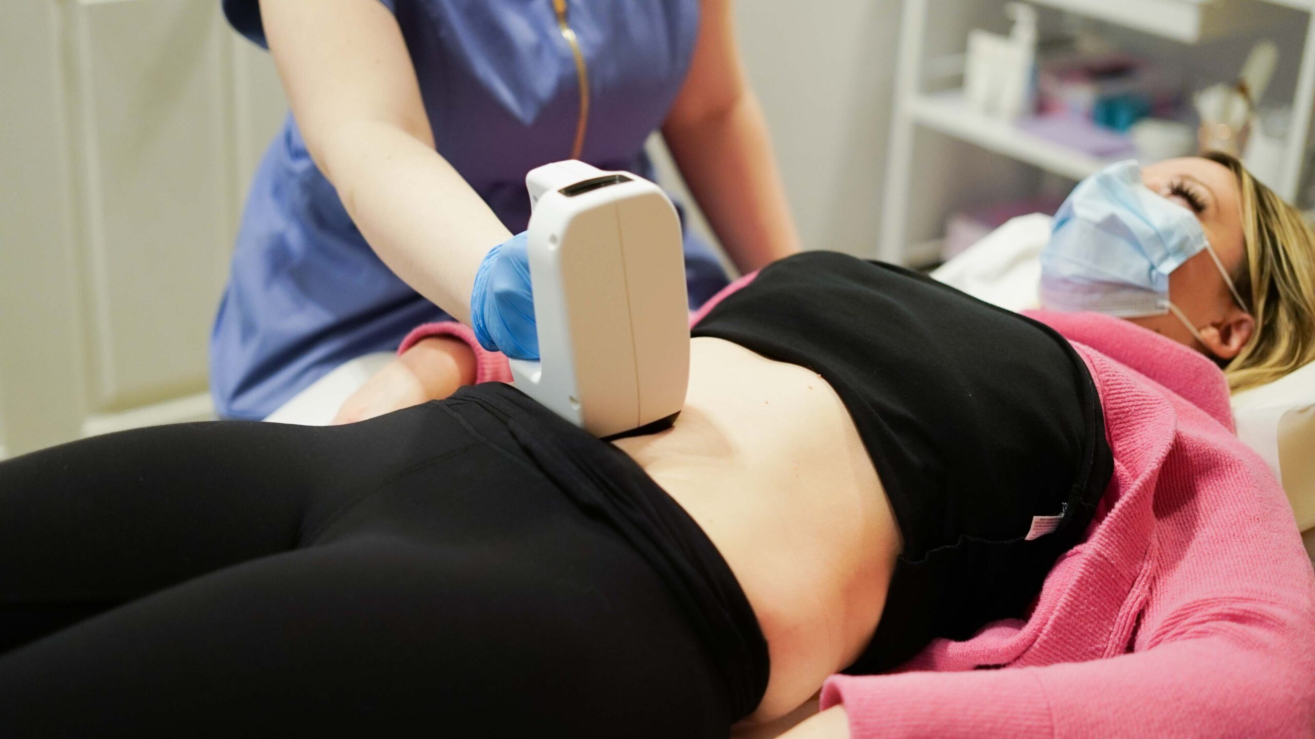 a medical procedure being performed on woman's stomach