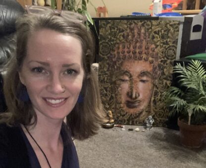 a woman in front of Buddha face painting