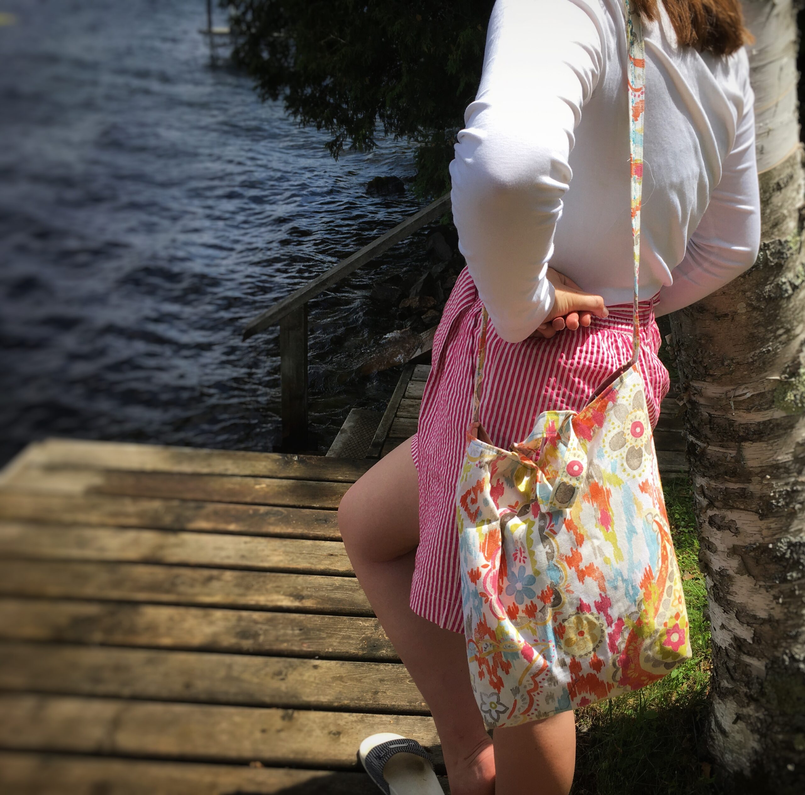 a girl on deck carrying sling bag