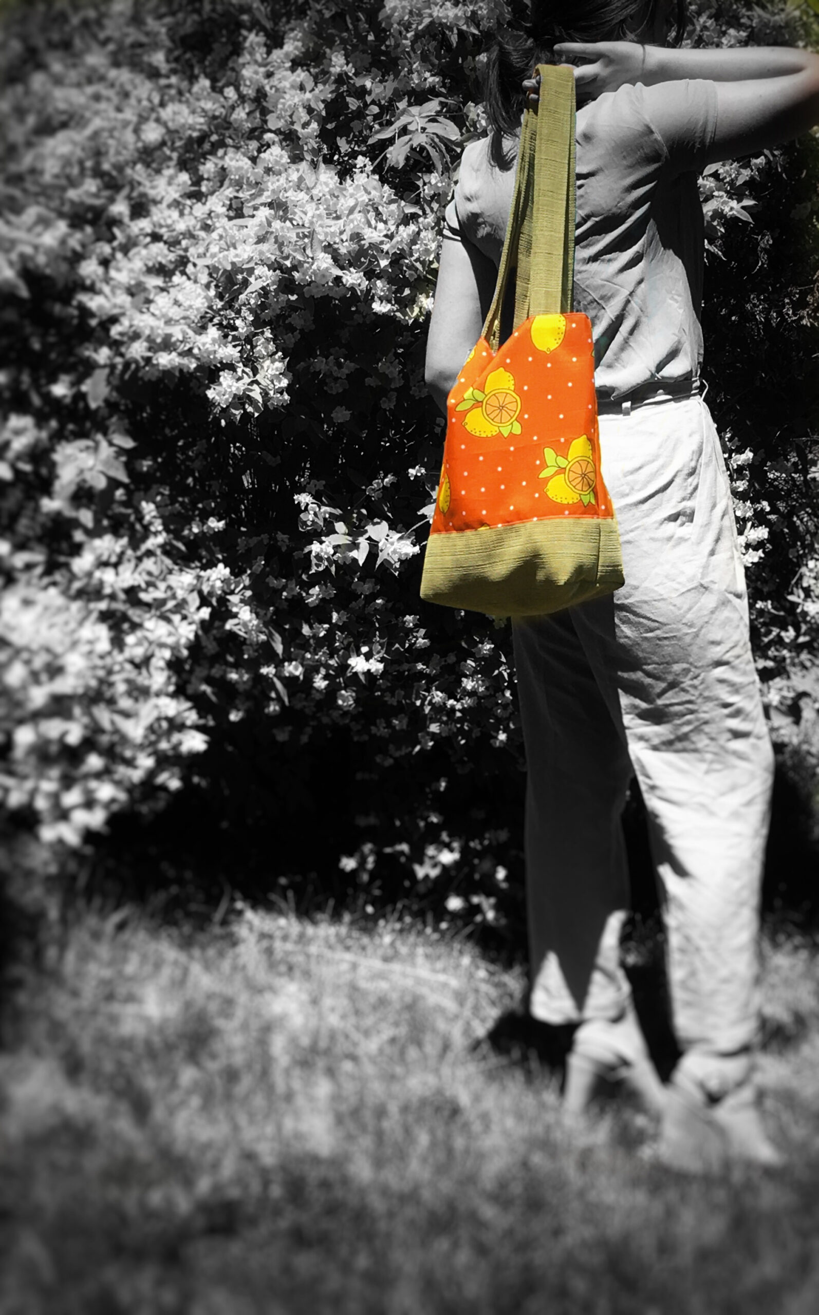 girl holding orange bag in black & white picture