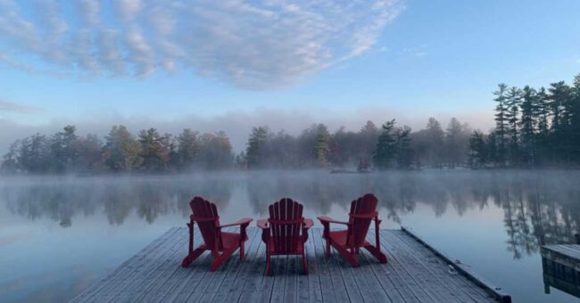 Chairs on the dock of a lake