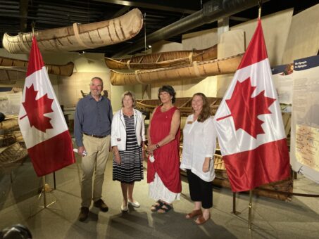 Group of people standing in line for announcement photo at Canoe Museum